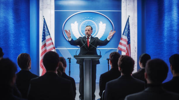 istock Charismatic Organization Representative Greeting Supporters at Conference in USA Government Building. Press Office Representative Delivering a Speech at a Summit. Minister Speaking to Congress. 1317961857