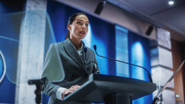 Portrait of Organization Female Representative Speaking at Press Conference in Government Building. Press Office Representative Delivering a Speech at Summit. Minister Speaking to Congress Hearing. Portrait of Organization Female Representative Speaking at Press Conference in Government Building. Press Office Representative Delivering a Speech at Summit. Minister Speaking to Congress Hearing. activist speech stock pictures, royalty-free photos & images