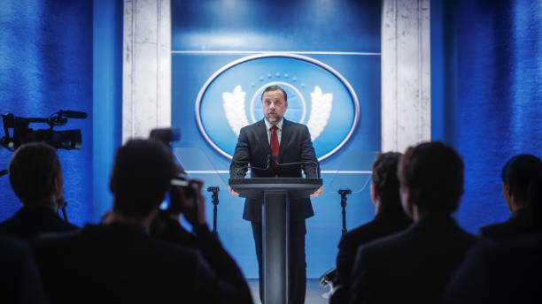 istock Charismatic Organization Representative Greeting Supporters at Conference in Government Building. Press Office Representative Delivering a Speech at a Summit. Minister Speaking to Congress. 1317961949