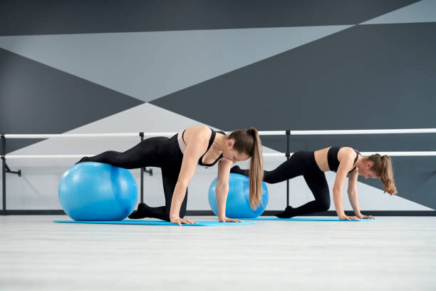 istock Women practicing plank position using fitness balls. 1317963047
