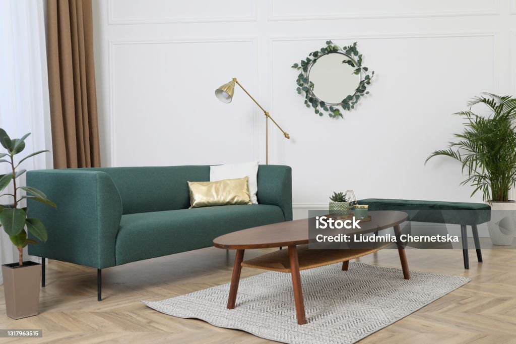 Stylish living room interior with comfortable sofa and wooden table Apartment Stock Photo