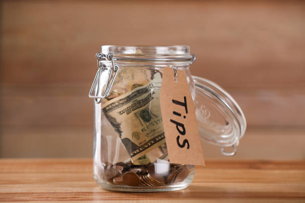 istock Glass jar with tips on wooden table, closeup 1317963518