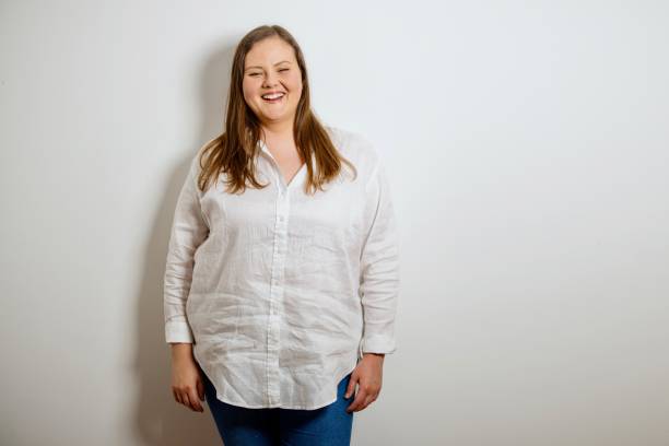 Cheerful plus size model in casual clothe Portrait of a confident plus size woman. Oversized woman posing and looking at camera on white background. Body Confidence, Body Positivity And Self Esteem plus size woman fashion laughing stock pictures, royalty-free photos & images