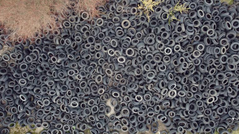 Aerial view of old tires. Many car and truck tires on dump site from above