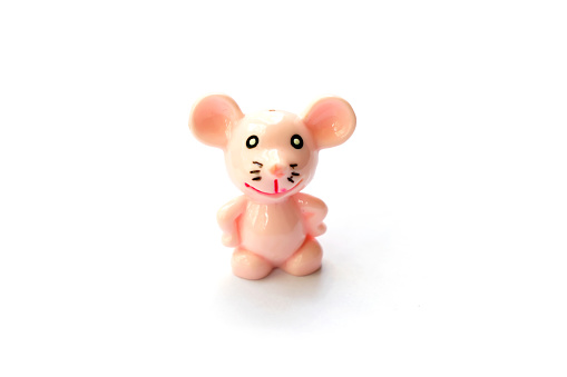 toy miniature pink mouse smiling isolated object on white background space for text
