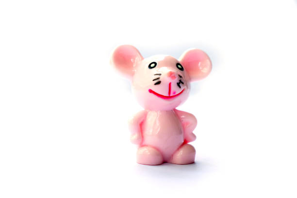 istock Isolated toy miniature pink mouse smiling on white background space for text. 1317966600