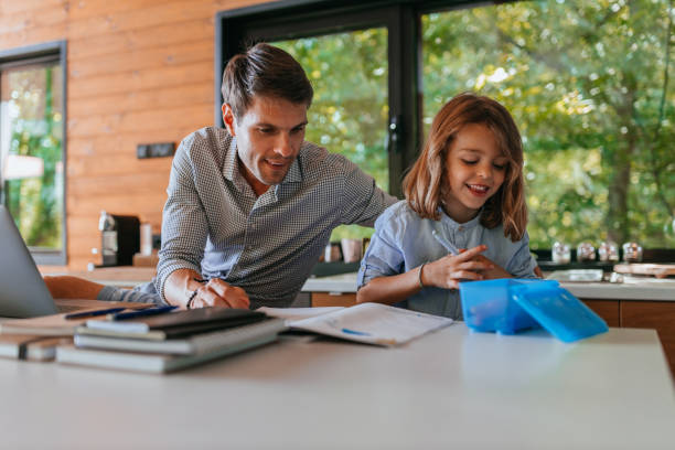 istock Single father helping his son about drawing at home 1317969416