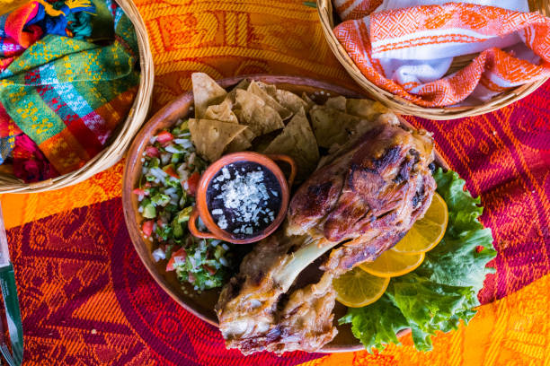 istock Roasted meat with vegetables and refried beans on colorful tablecloth 1317971654