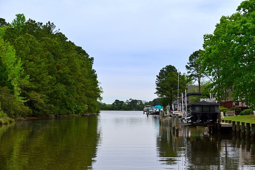 Waterfront houses and recreational bots on canal on a spring morning in Ocean Pines, MD