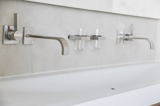 istock Shiny wall mount faucets above basin 1317972876