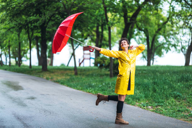 istock Woman in park at rain 1317973303