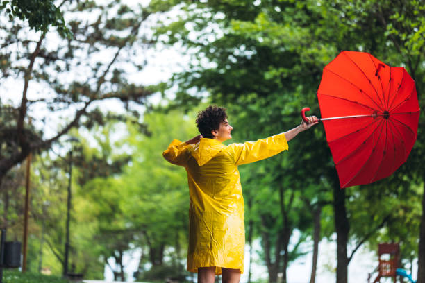 istock Woman in park at rain 1317973325