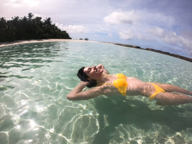 istock Woman floating in water on Maldives 1317973980