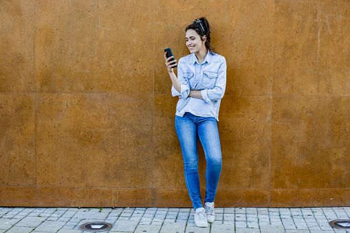 Portrait of young woman with smart phone