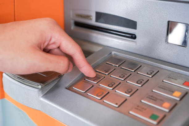 istock Press ATM PIN, Finger entering PIN pass code on Bank Machine Keypad. Automated teller machine is electronic telecommunications device that enables customers of financial institutions to transactions 1317976343
