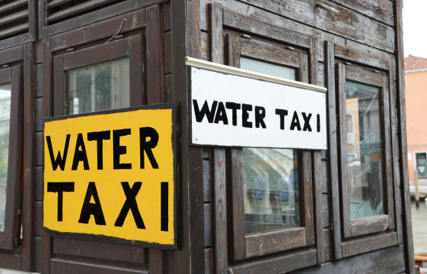 sign with the inscription water taxi which are the special boats for the transport of people in the city of venice - travel outdoors tourist venice italy imagens e fotografias de stock