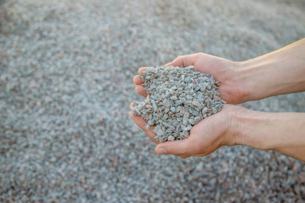 istock Man holding small rubble in his hands selective focus 1317981625