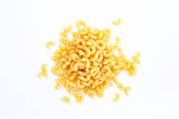 istock Various uncooked pasta on white background. Top view. Raw pasta with ingredients for cooking. Food concept 1317981672