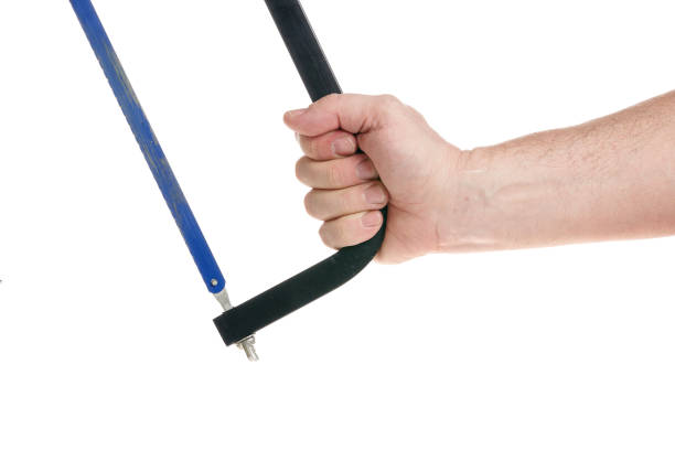 istock Hand holds a hacksaw on a white background, a template for designers, a template for designers. Close up 1317982118