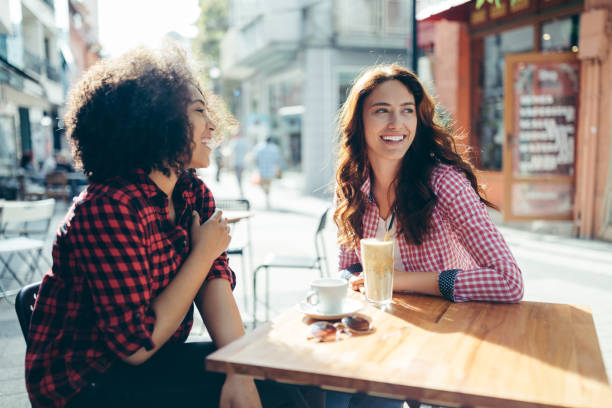 istock Young women at sidewalk cafe 1317983250