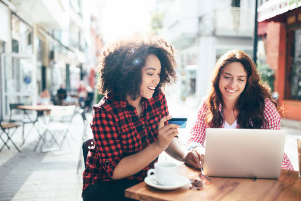 istock Girls drinking coffee and shopping online 1317983282