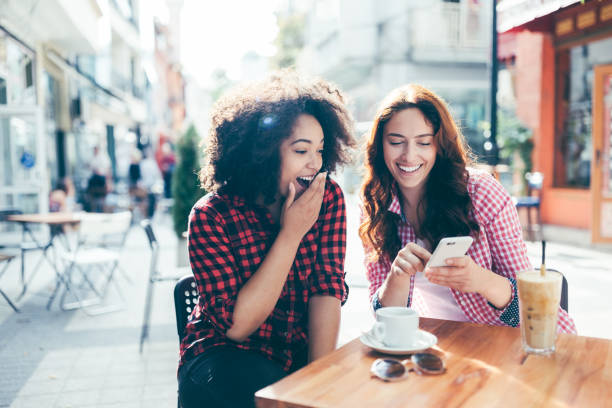 istock Young women at sidewalk cafe 1317983292