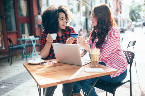 istock Girls drinking coffee and shopping online 1317983321