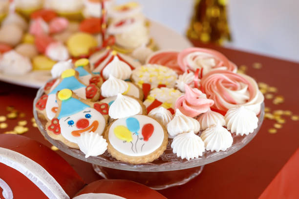 istock Multi coloured sweets and cupcakes on white plates on the table 1317985735