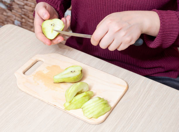 istock Preparation of ripe pears for making a pie. Selective focus. 1317985880
