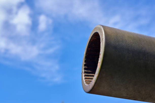 istock Tank cannon on a background of blue sky, close-up. 1317988198