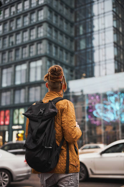 istock Male tourist with backpack walking in city centre 1317990029