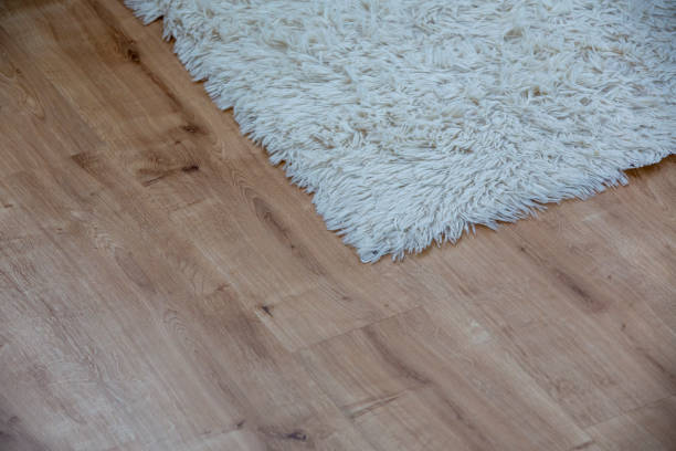 istock white carpet on parquet floor 1317994334