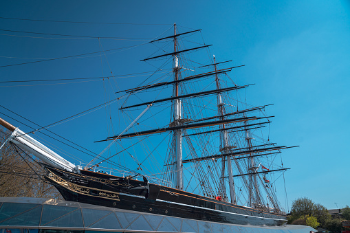 Aker Brygge in Oslo with a sailing ship lying in the Oslofjord  with ice floes, Norway, on a beautiful cold sunny day with blue sky.