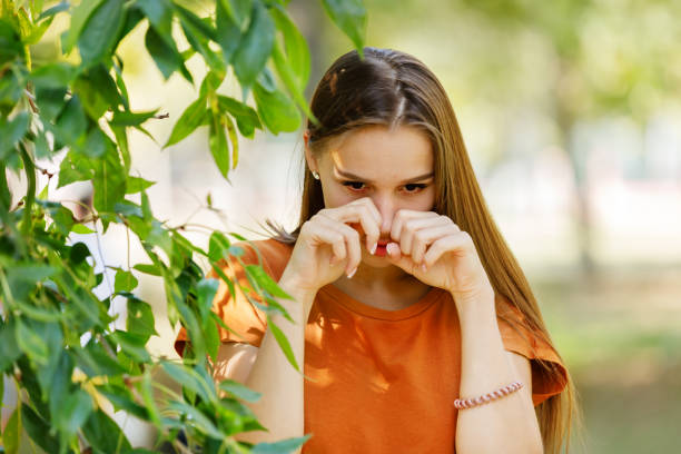 Allergic Woman with Long Hair is Rubbing her Eyes in the Park. Beautiful Woman with Sight or Allergy Problems is Rubbing her Eyes During the Walk in a City Park on Sunny Day. human eye scratching allergy rubbing stock pictures, royalty-free photos & images