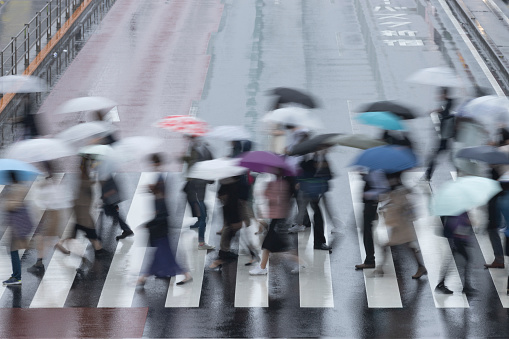 Pedestrians crossing the street in the rain