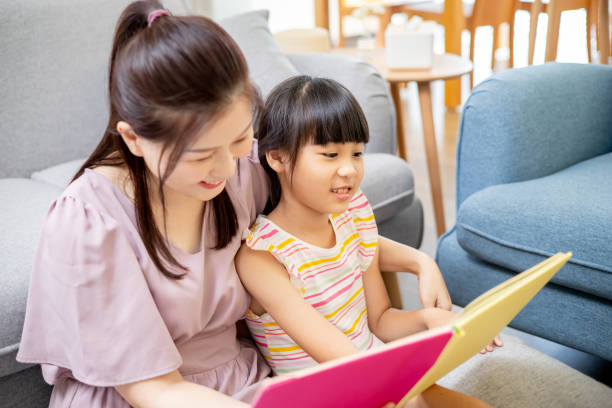 istock Mother and daughter reading book 1317996845