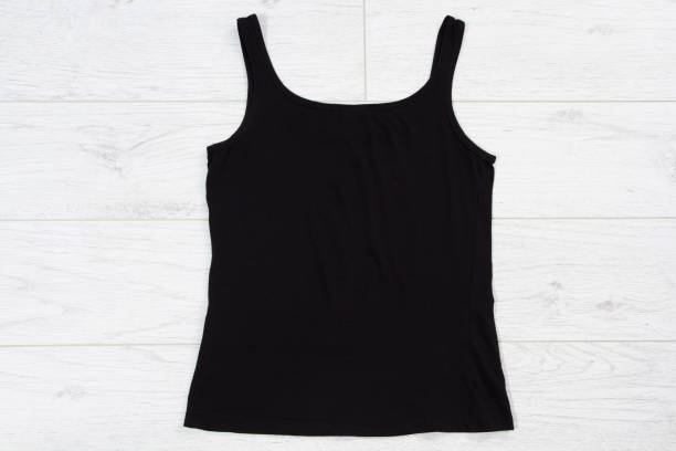 istock Black tank top tshirt template mock up on white wooden background top view. 1317996864