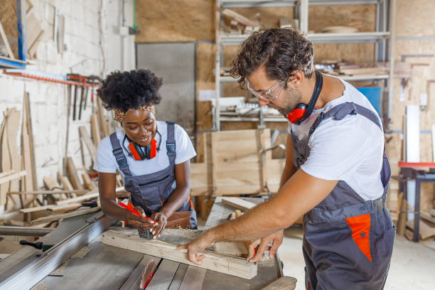 istock A Carpentry Workers are Working in Large Workshop Using a Measuring Tape to Mark the Wooden Plank. 1317996972