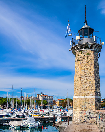 The nineteenth-century lighthouse stands out at the marina of Desenzano del Garda, one of the charming towns on Lake Garda, the largest Italian lake.