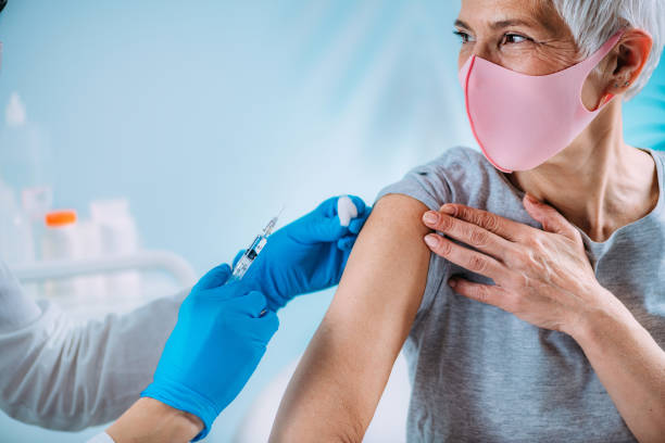 istock Senior Woman Getting a Coronavirus Vaccine 1318001618