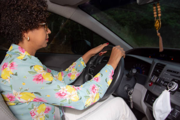 istock Woman driving car in the night 1318001868