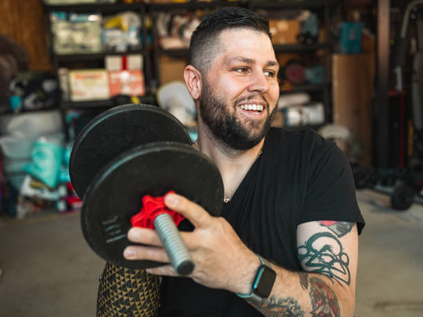 istock Man with disability working out in garage 1318002625