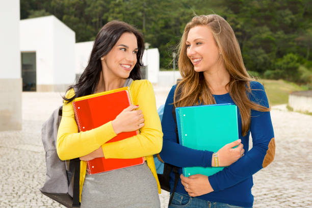 istock Two beautiful teenage students 1318006496