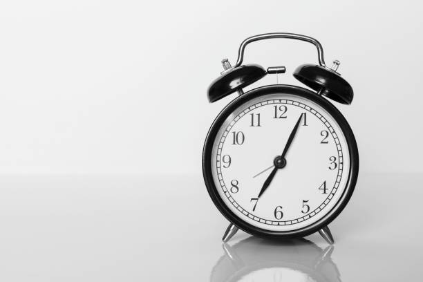 istock Classic black alarm clock on white background. Time concept. 1318006826