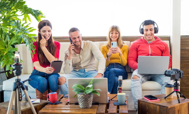 istock Addicted multicultural group of friends ignoring live communication while chatting in social networks or smartphones using wireless 5G internet at home.four people overwhelmed with technology.lifestyle 1318007626