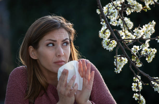 istock Woman afraid of blooming tree 1318007967
