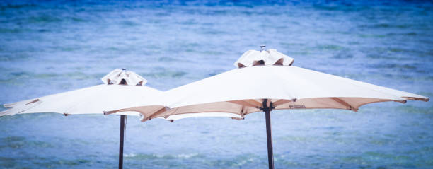 istock Beach umbrella summer sea background 1318008050