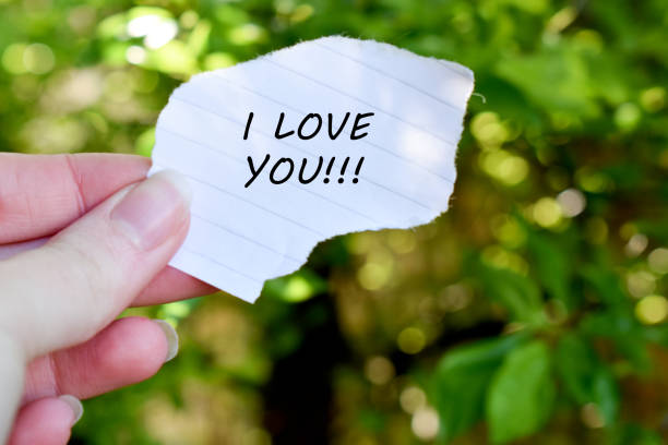 istock Human hand holding a paper with I love you text 1318008998