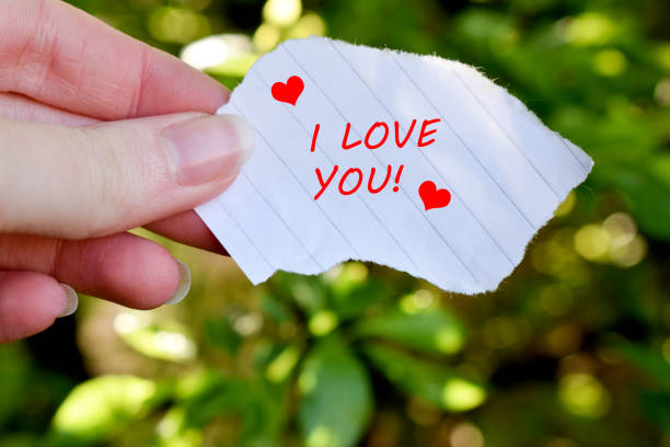 istock Human hand holding a paper with I love you text 1318009283