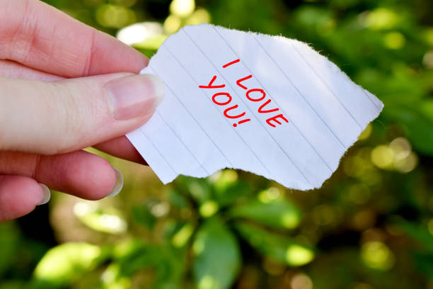 istock Human hand holding a paper with I love you text 1318009323